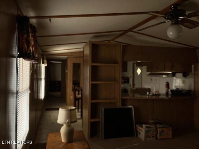 living room with a ceiling fan and lofted ceiling
