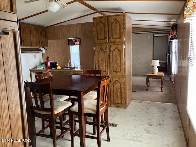 dining room featuring vaulted ceiling and a ceiling fan