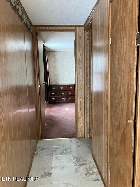 hall featuring wood walls
