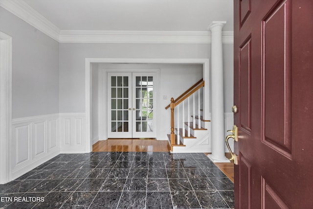foyer featuring ornamental molding, french doors, marble finish floor, and stairway