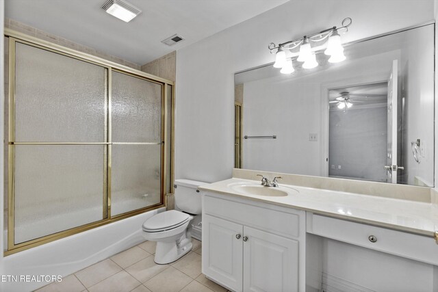 full bath featuring tile patterned floors, combined bath / shower with glass door, vanity, toilet, and visible vents