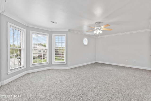 unfurnished room featuring ceiling fan, baseboards, ornamental molding, and visible vents