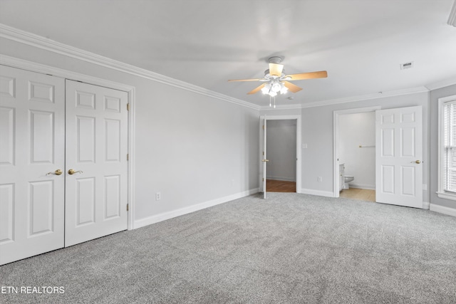 unfurnished bedroom featuring baseboards, crown molding, and carpet flooring