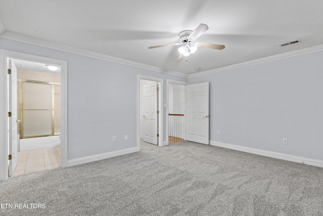 unfurnished bedroom featuring carpet floors, crown molding, visible vents, and baseboards