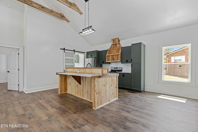 kitchen featuring a barn door, dark wood-style floors, high vaulted ceiling, and stainless steel appliances