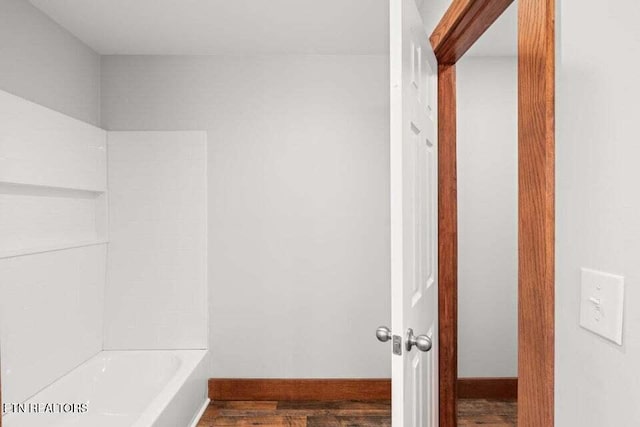 full bath featuring wood finished floors and baseboards