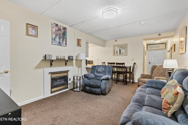 carpeted living area with baseboards, a glass covered fireplace, and a textured ceiling