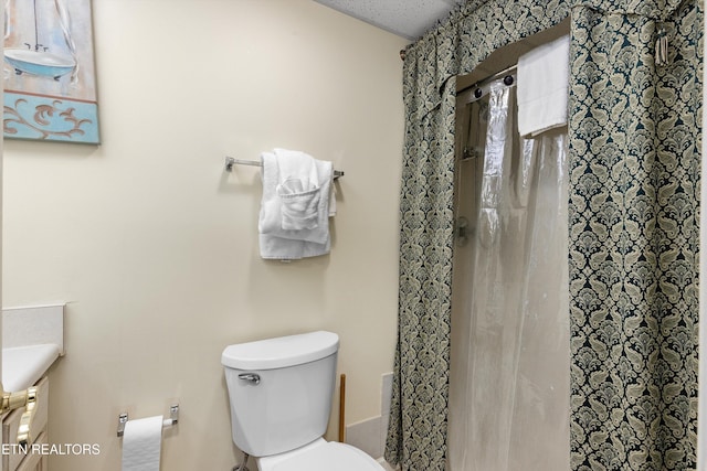 bathroom featuring toilet and a shower with shower curtain