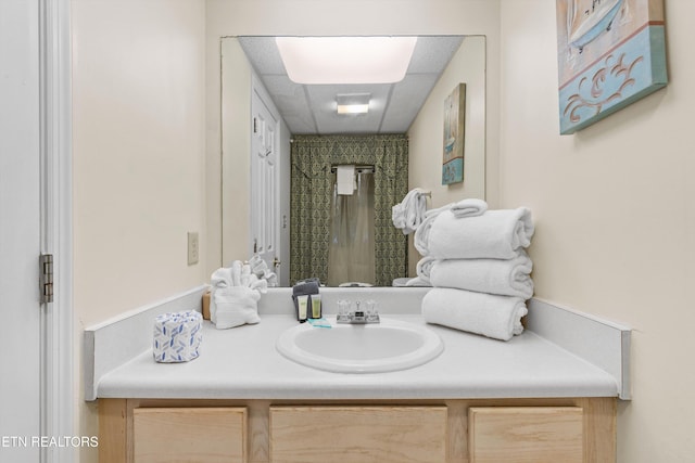 bathroom with a shower with curtain and vanity