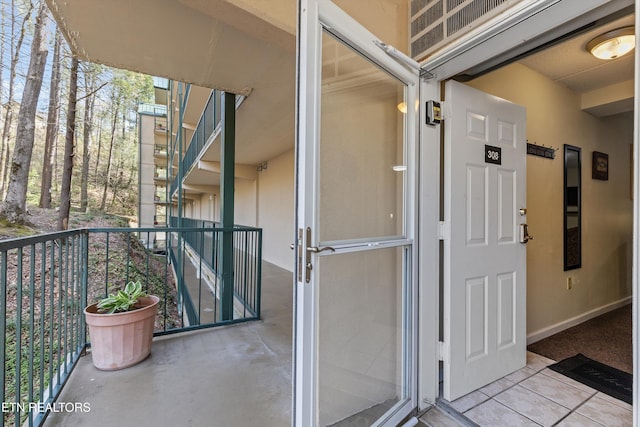 exterior space with stucco siding and a balcony