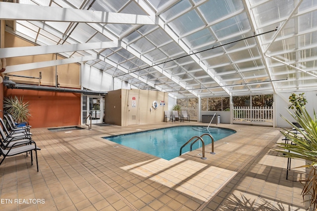 community pool with a patio and fence