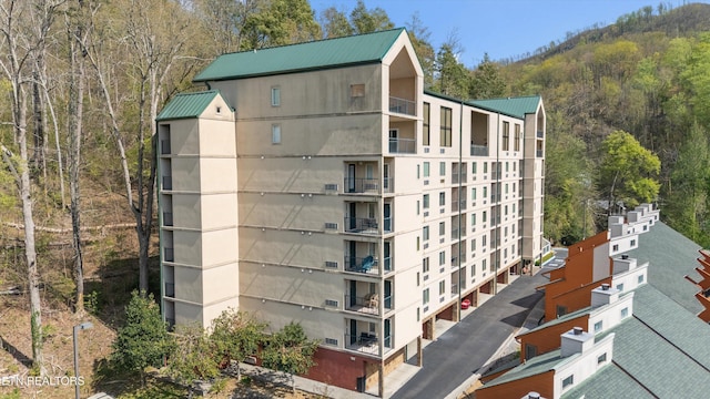 view of building exterior featuring a forest view
