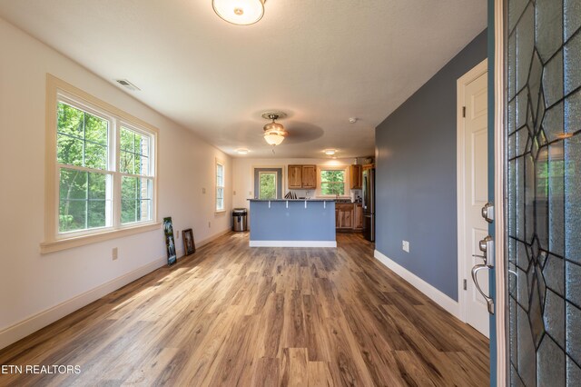 537 Wilson St, Newport, TN 37821 - kitchen featuring freestanding refrigerator, visible vents, baseboards, wood finished floors, and brown cabinetry