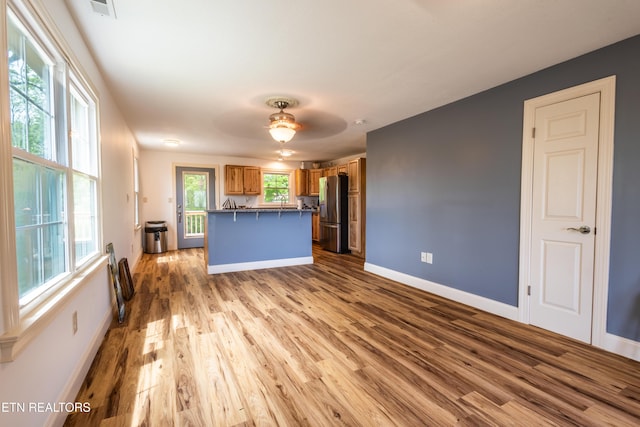 537 Wilson St, Newport, TN 37821 - unfurnished living room featuring visible vents, baseboards, a ceiling fan, and wood finished floors