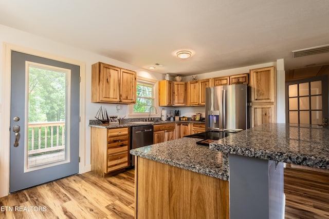 537 Wilson St, Newport, TN 37821 - kitchen with a sink, dark stone counters, visible vents, light wood-style floors, and appliances with stainless steel finishes