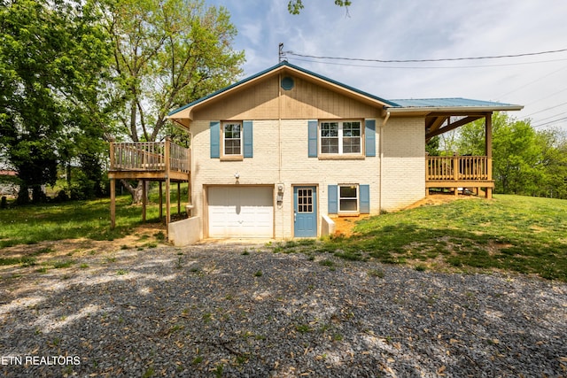 537 Wilson St, Newport, TN 37821 - view of side of home with metal roof, brick siding, a wooden deck, an attached garage, and gravel driveway
