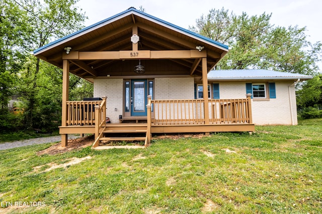 537 Wilson St, Newport, TN 37821 - view of front facade featuring a front lawn, brick siding, and a deck