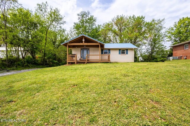 537 Wilson St, Newport, TN 37821 - view of front of house with concrete block siding, a front lawn, and a deck
