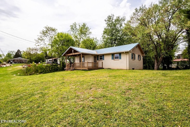 537 Wilson St, Newport, TN 37821 - rear view of house featuring a lawn, a wooden deck, brick siding, and metal roof
