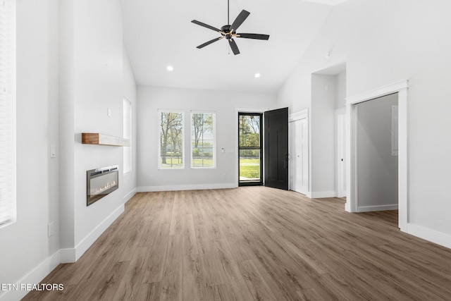 103 E Main St, Englewood, TN 37329 - unfurnished living room featuring baseboards, wood finished floors, heating unit, and a glass covered fireplace