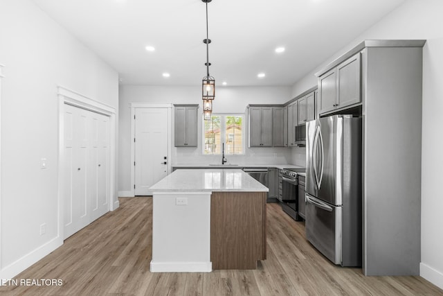 103 E Main St, Englewood, TN 37329 - kitchen featuring baseboards, a center island, gray cabinetry, stainless steel appliances, and a sink