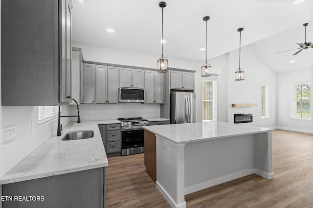 103 E Main St, Englewood, TN 37329 - kitchen featuring gray cabinets, a center island, a ceiling fan, appliances with stainless steel finishes, and a sink