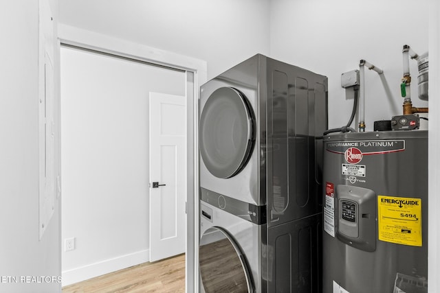 103 E Main St, Englewood, TN 37329 - laundry area with baseboards, light wood-type flooring, laundry area, stacked washer / drying machine, and water heater