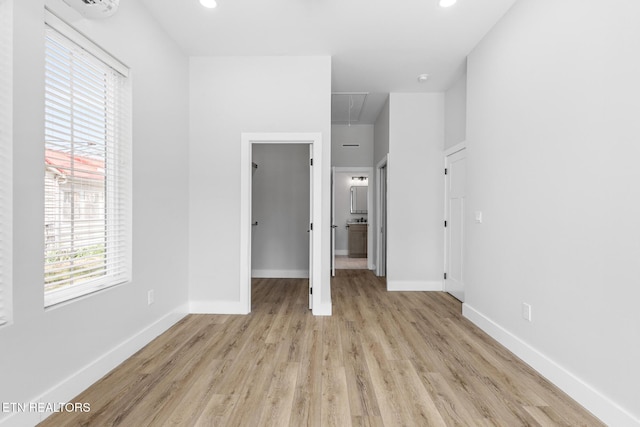 103 E Main St, Englewood, TN 37329 - unfurnished bedroom featuring light wood-style flooring, a spacious closet, attic access, and baseboards