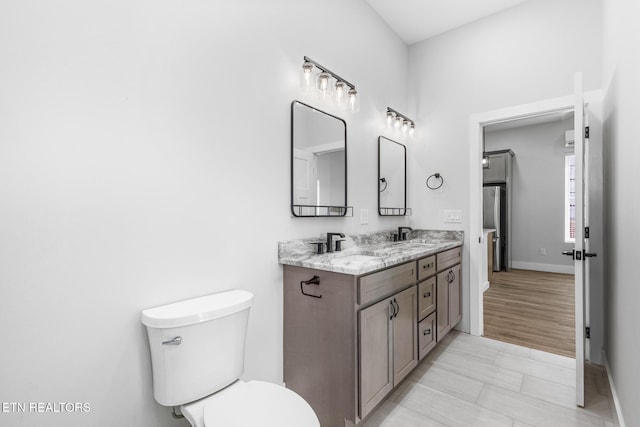 103 E Main St, Englewood, TN 37329 - full bathroom with toilet, double vanity, a sink, and baseboards