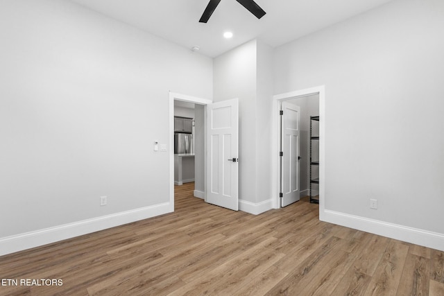 103 E Main St, Englewood, TN 37329 - unfurnished bedroom featuring baseboards, freestanding refrigerator, recessed lighting, a towering ceiling, and wood finished floors