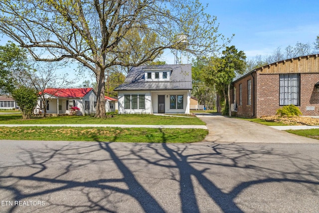 103 E Main St, Englewood, TN 37329 - bungalow featuring a front yard, brick siding, and driveway