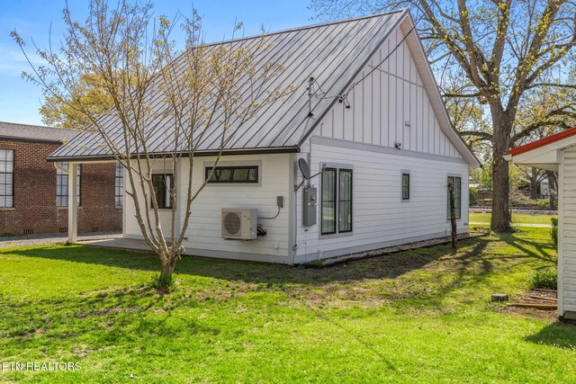 103 E Main St, Englewood, TN 37329 - rear view of house with ac unit, a yard, metal roof, and a standing seam roof