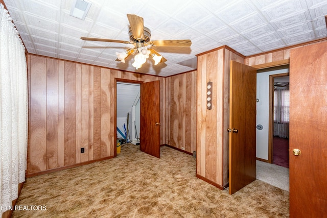 285 Telford St, Alcoa, TN 37701 - spare room with wooden walls, baseboards, a ceiling fan, and carpet flooring