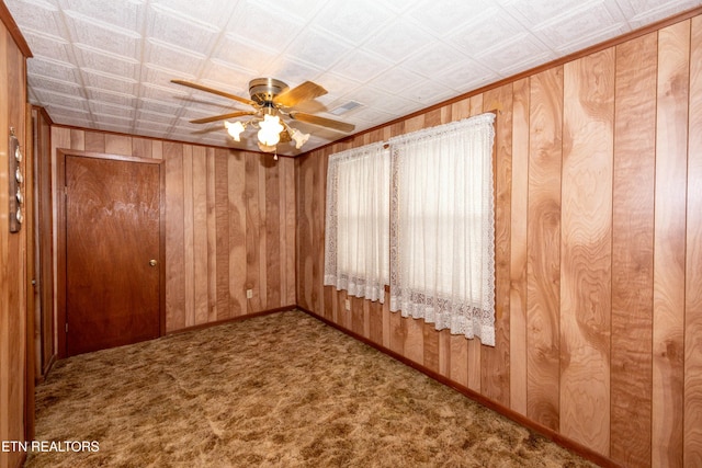 285 Telford St, Alcoa, TN 37701 - carpeted empty room with wood walls, ceiling fan, and baseboards