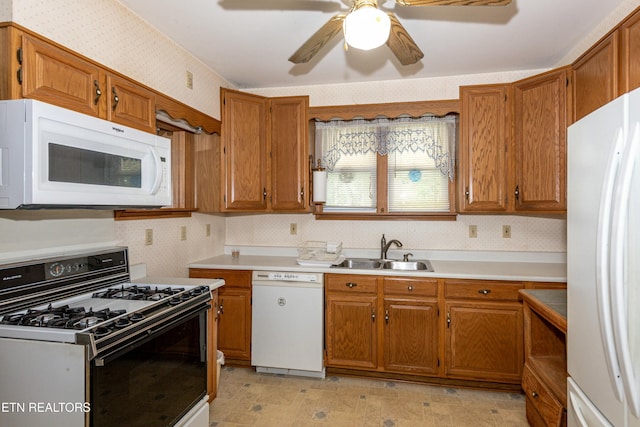 285 Telford St, Alcoa, TN 37701 - kitchen featuring ceiling fan, white appliances, brown cabinetry, a sink, and wallpapered walls