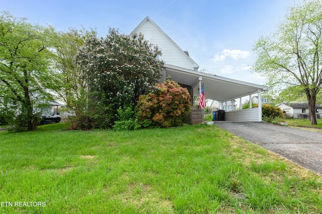 285 Telford St, Alcoa, TN 37701 - view of front of house featuring an attached carport, aphalt driveway, and a front lawn