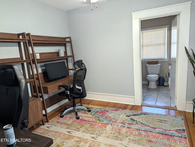 home office featuring wood finished floors and baseboards
