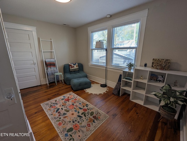 sitting room with wood finished floors, baseboards, and visible vents