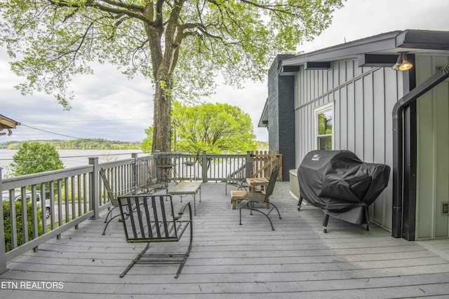 wooden deck featuring a grill