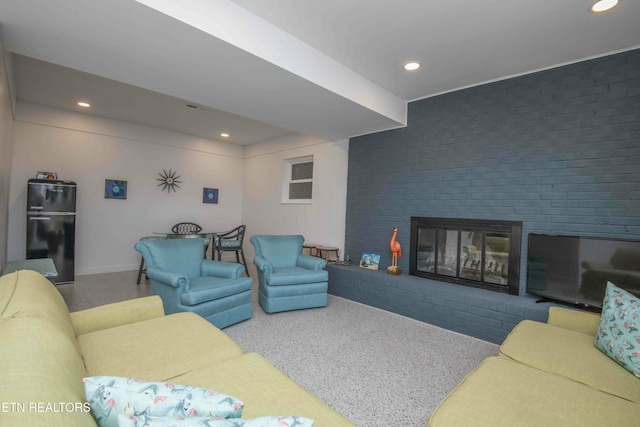 carpeted living room featuring baseboards, a fireplace, and recessed lighting