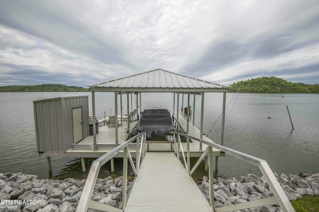 view of dock featuring a water view and boat lift