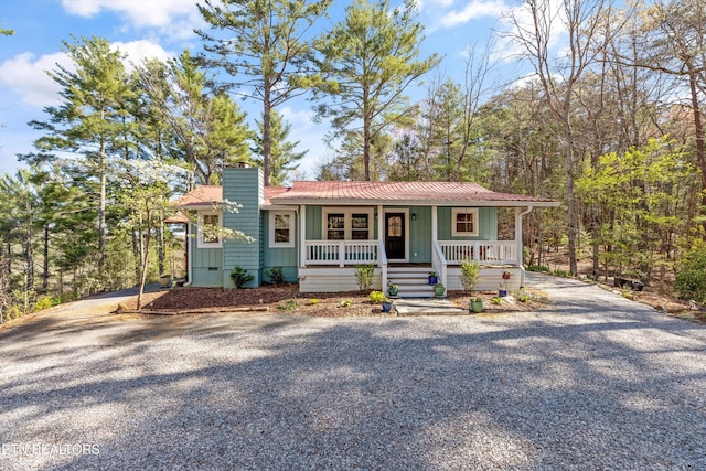 151 Gold Miners Rd, Tellico Plains, TN 37385 - view of front of home with a porch, gravel driveway, a chimney, and board and batten siding