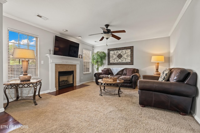7300 Slippery Rock Ln, Knoxville, TN 37931 - living room with crown molding, wood finished floors, ceiling fan, a tiled fireplace, and baseboards