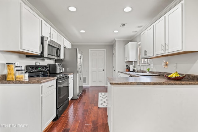 7300 Slippery Rock Ln, Knoxville, TN 37931 - kitchen featuring electric range, stainless steel microwave, ornamental molding, visible vents, and recessed lighting