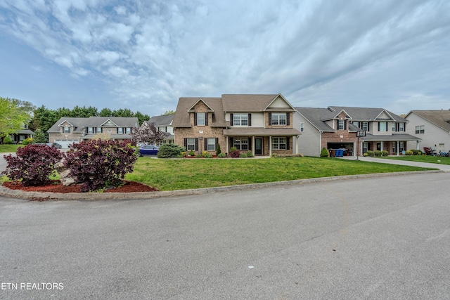 7300 Slippery Rock Ln, Knoxville, TN 37931 - view of front of home featuring a residential view, concrete driveway, brick siding, a front yard, and a garage