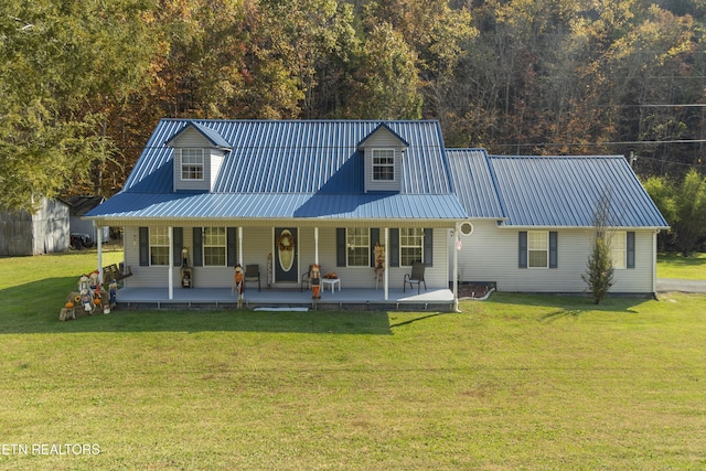 back of house with a lawn, a porch, and metal roof