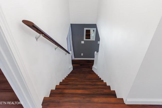 stairs featuring wood finished floors