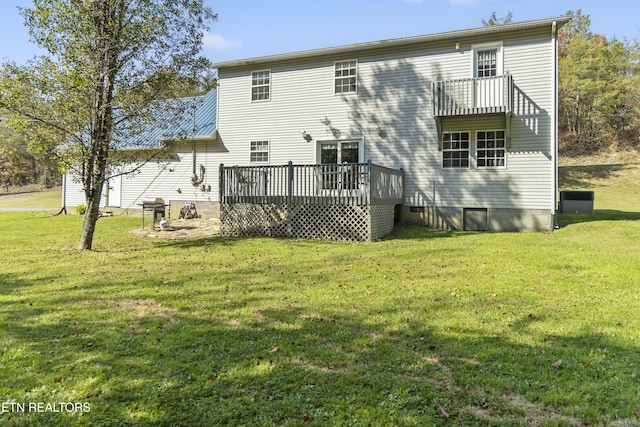 back of property featuring a wooden deck, a yard, and crawl space