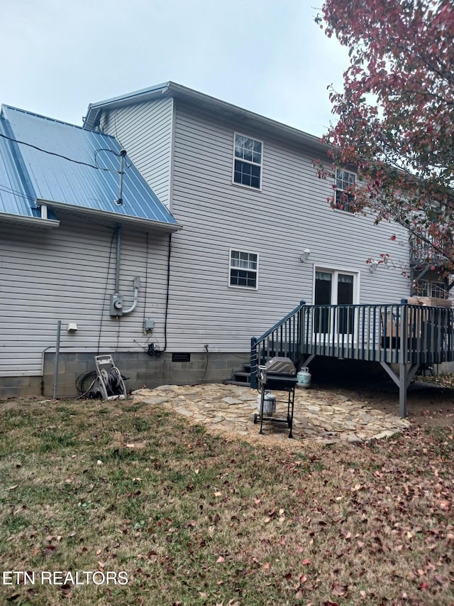 back of property featuring a deck