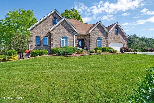 300 Lowe Rd, Huntsville, TN 37756 - view of front of house with concrete driveway, a front yard, and brick siding